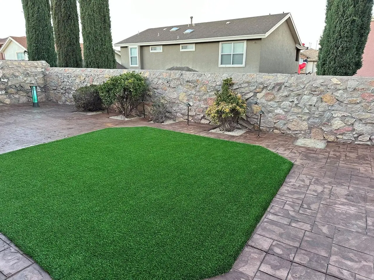 Artificial turf and stamped concrete